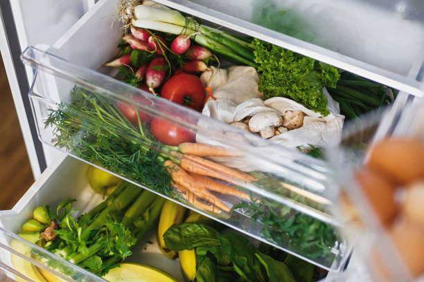 istock Zero waste grocery in fridge. Fresh vegetables in opened drawer in refrigerator. Plastic free carrots,tomatoes, mushrooms,radish,salad, arugula, zero waste shopping concept.Vegetarian diet 1156620780