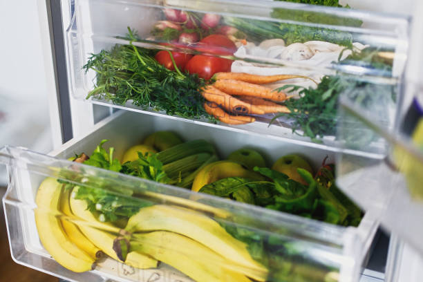 istock Zero waste grocery in fridge. Fresh vegetables in opened drawer in refrigerator. Plastic free carrots,tomatoes, mushrooms,bananas,salad, celery, apples, zero waste shopping. Grocery delivery 1156620825