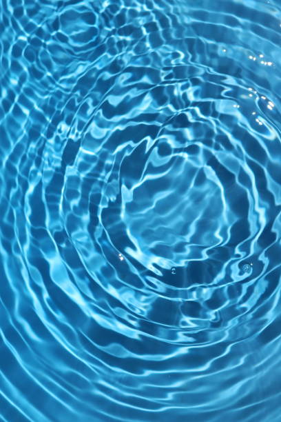 istock Blue and bright water surface with sun refection in swimming pool for background 1156623178