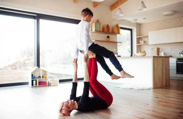 istock A young woman with small son playing on the floor, having fun. 1156626952