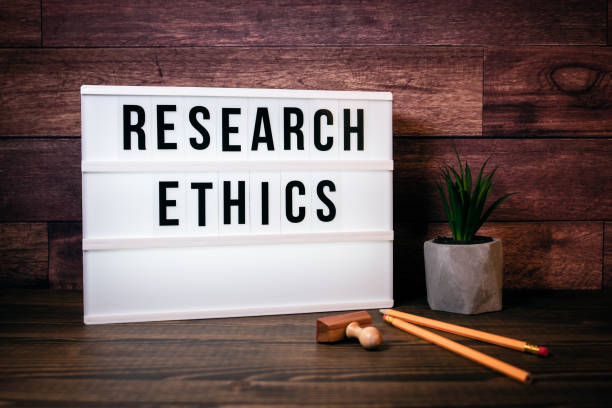 Research Ethics. Text in Lightbox Research Ethics. Text in lightbox. Wooden office table research ethics stock pictures, royalty-free photos & images