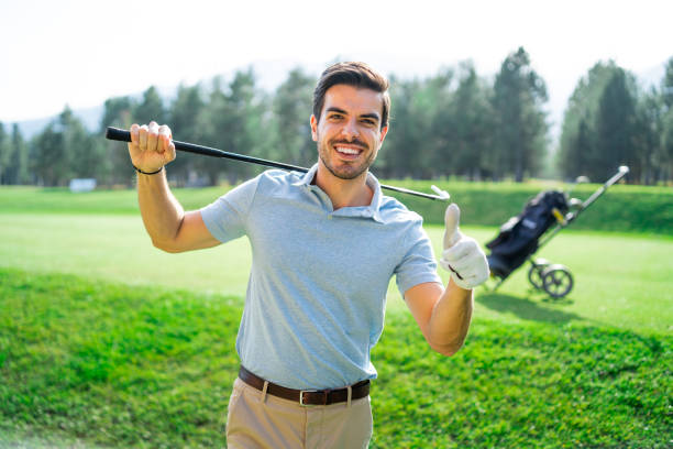 istock Male golfer standing on golf course and gesturing thumb up 1156637269