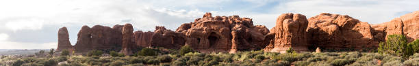 istock Red rock natural arches stretch the panoramic horizon 1156637395