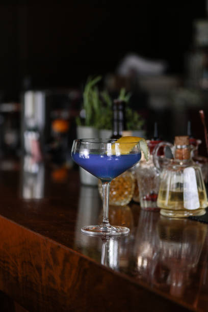 istock Blue Cocktail with Orange Slice on bar counter 1156637648