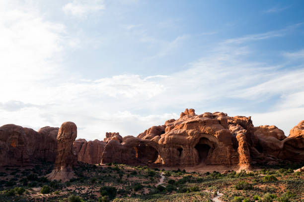 istock Sun rises over natural red rock arches of Utah 1156638792