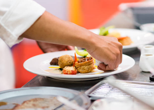istock Chef preparing food in the kitchen, chef cooking, Chef decorating dish 1156640037