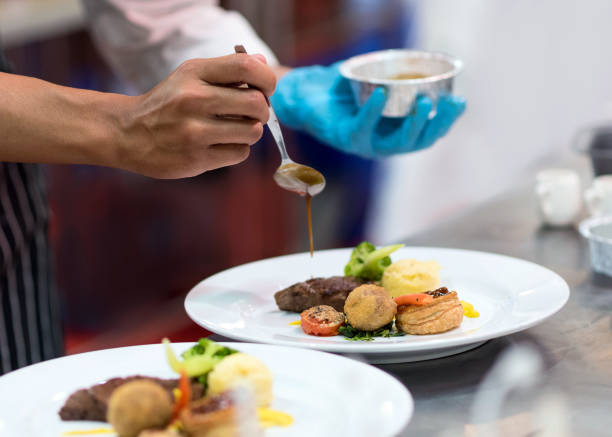 istock Chef preparing food in the kitchen, chef cooking, Chef decorating dish 1156640044