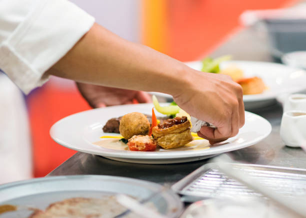 istock Chef preparing food in the kitchen, chef cooking, Chef decorating dish 1156640052