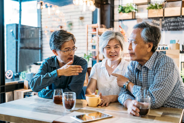 istock Asian family having breakfast and talking in bar 1156640267