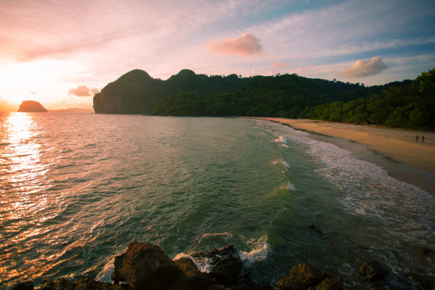 istock Amazing Sunset at the beach, with sea waves 1156640402