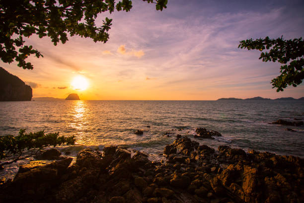 istock Amazing Sunset at the beach, with sea waves 1156640405