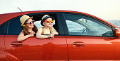 happy children girl and boy goes to summer travel trip in car