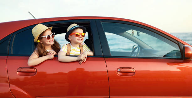 happy children girl and boy goes to summer travel trip in car - 11262 imagens e fotografias de stock
