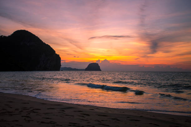 istock Amazing Sunset at the beach, with sea waves 1156640620