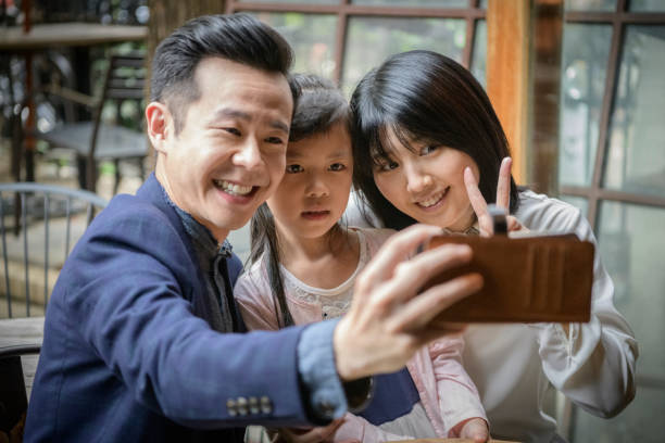 istock Asian family taking selfie together 1156641881