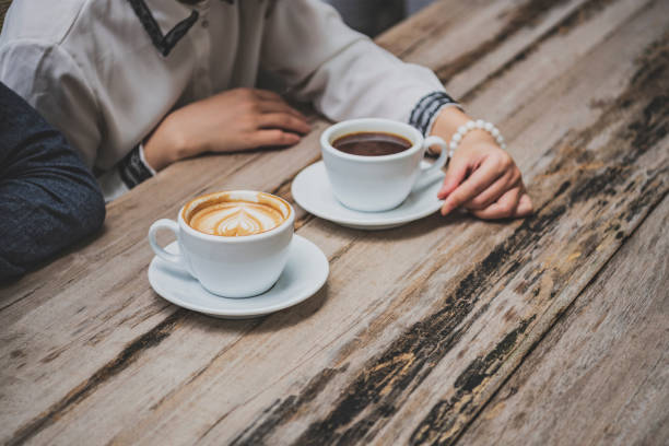 Cropped image of black coffee and cappuccino, taking a break, cafe, togetherness