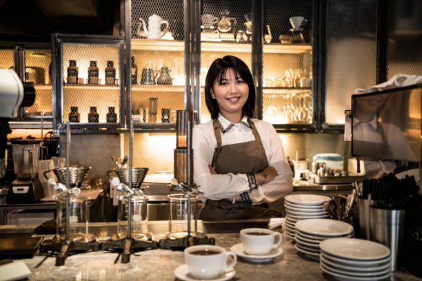 istock Female barista with arms folded standing at counter 1156641927