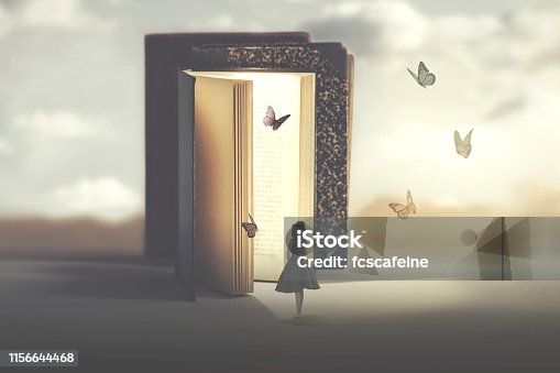 istock poetic encounter between a woman and butterflies coming out of a book 1156644468