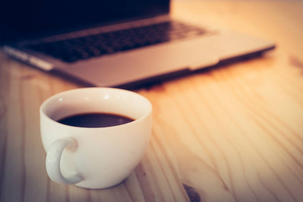 istock Laptop and coffee cup on wood table with copy-space. 1156645920