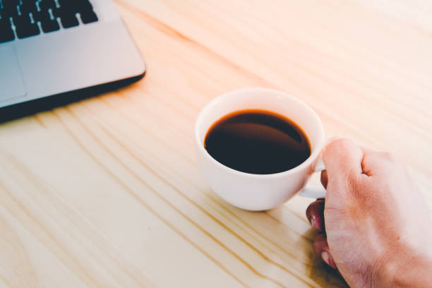 istock Laptop and coffee cup on wood table with copy-space. 1156646426