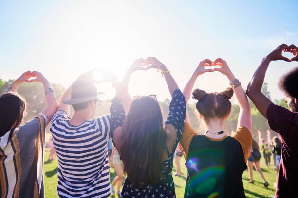 istock Rear view of friends making a heart with hands 1156646834