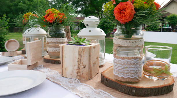 istock Details of a rustic wedding table with wooden elements orange roses 1156648843