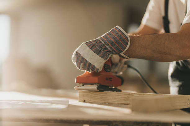 istock Close up of construction worker using sander while working on a wood plank. 1156649797
