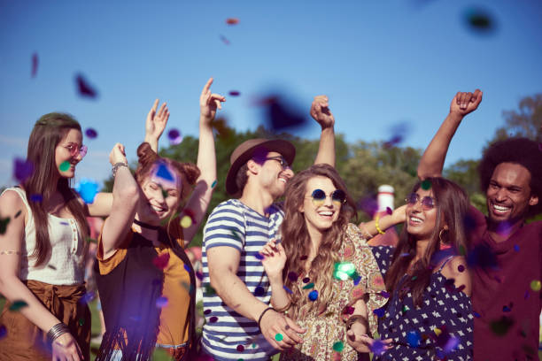 istock Group of friends dancing in confetti 1156650400