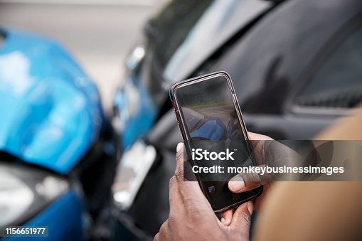 istock Male Motorist Involved In Car Accident Taking Picture Of Damage For Insurance Claim 1156651977