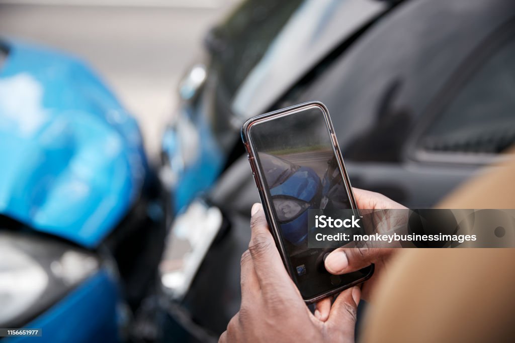 Male Motorist Involved In Car Accident Taking Picture Of Damage For Insurance Claim Car Accident Stock Photo