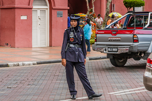 A policewoman in the historical downtown of Malacca