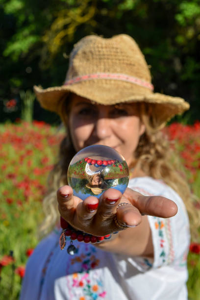 istock Woman hands out a glass globe. 1156654612