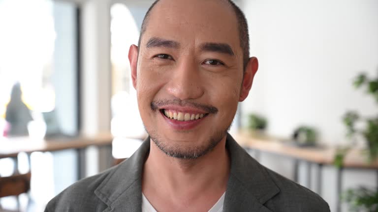 Chinese businessman portrait with shaved head laughing