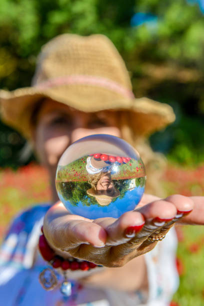 istock Woman hands out a glass globe. 1156655382