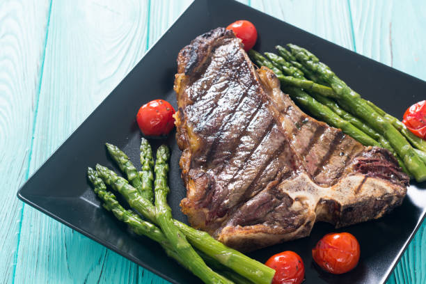 istock Grilled T-bone steak with asparagus and cherry tomatoes 1156656204