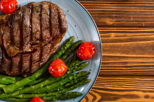 istock Grilled beef steak ribeye with cherry tomatoes and asparagus 1156656206