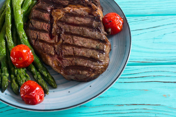 istock Grilled beef steak ribeye with cherry tomatoes and asparagus 1156656208