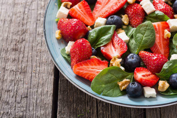 istock Summer Strawberry salad with spinach , cheese , nuts and blueberry 1156656251