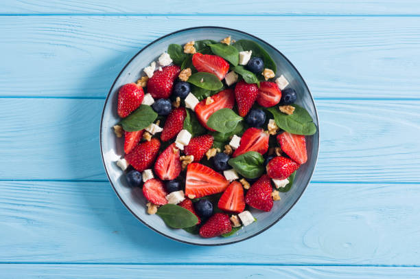 istock Summer Strawberry salad with spinach , cheese , nuts and blueberry 1156656256