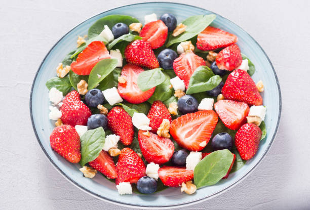 istock Summer Strawberry salad with spinach , cheese , nuts and blueberry 1156656261