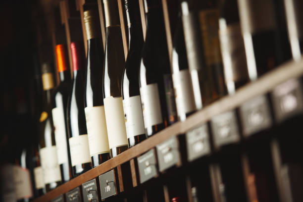 istock Wine cellar with elite drinks on shelves with written names 1156658753