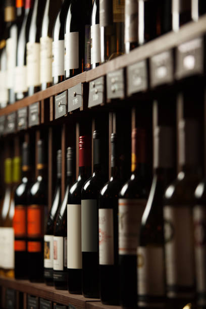 istock Wine cellar with elite drinks on shelves with written names 1156658816