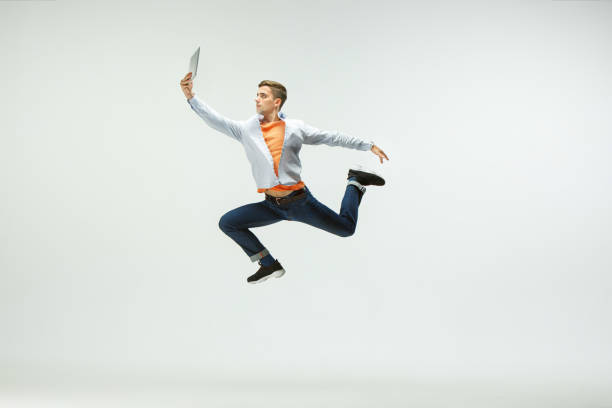 istock Man working at office and jumping isolated on studio background 1156659970