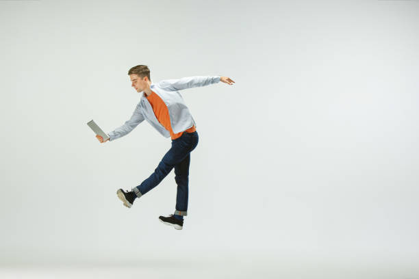 istock Man working at office and jumping isolated on studio background 1156659978