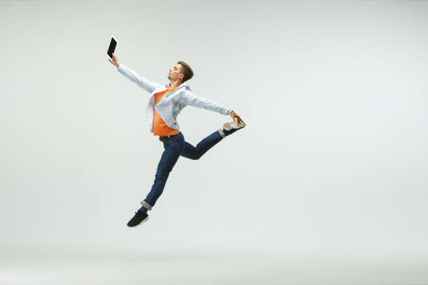 istock Man working at office and jumping isolated on studio background 1156659979