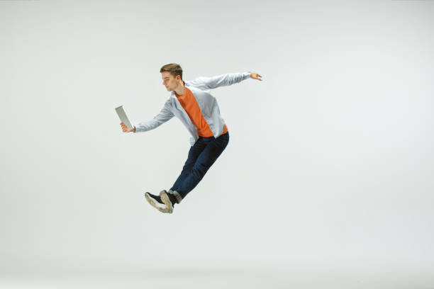 istock Man working at office and jumping isolated on studio background 1156659986