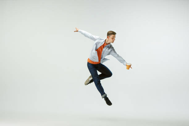 istock Man working at office and jumping isolated on studio background 1156659989