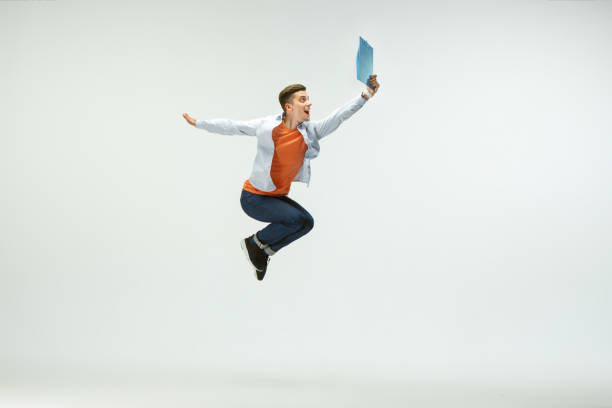 istock Man working at office and jumping isolated on studio background 1156659990