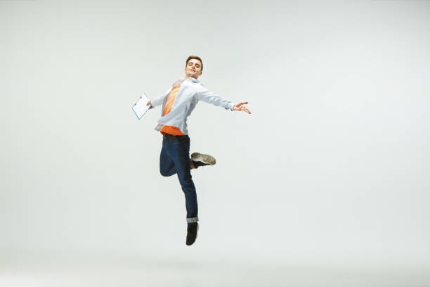 istock Man working at office and jumping isolated on studio background 1156659997