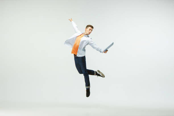 istock Man working at office and jumping isolated on studio background 1156660002